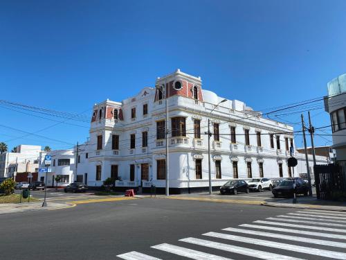 a white building on the corner of a street at Villa La Punta in Lima