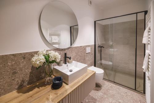 a bathroom with a sink and a mirror at Vila ROBIDA & SPA in Črni Kal