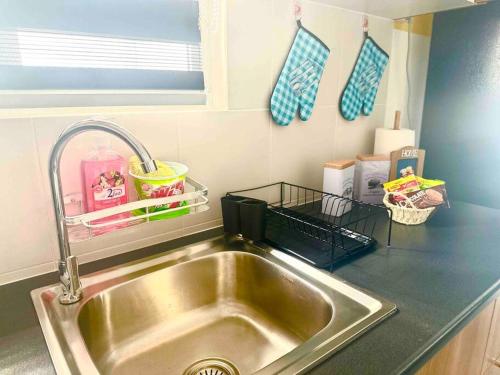 a kitchen counter with a sink in a kitchen at AF Homestay 2 Bedrooms 15mins to KLIA Free Wifi Netflix in Sepang