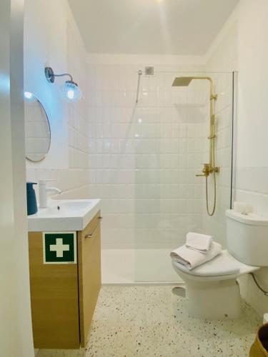 a bathroom with a shower and a toilet and a sink at Bright modern 3 BR in Portimao downtown in Portimão