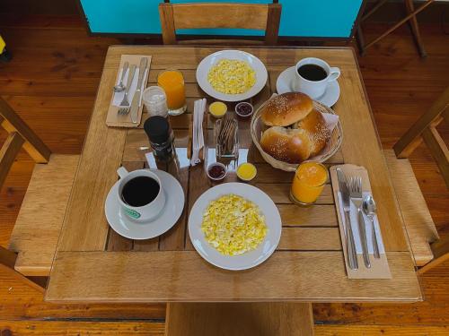 a table with plates of food and coffee and eggs at Villa La Punta in Lima