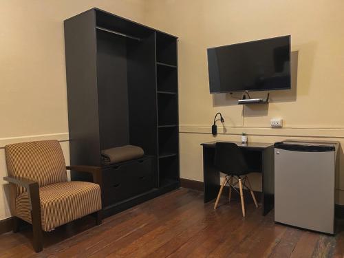 a room with a desk and a tv and a chair at Villa La Punta in Lima
