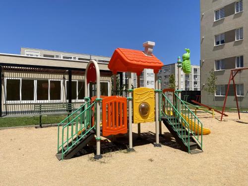 a playground with a slide in a park at Departamento Sor Vicenta in Los Ángeles