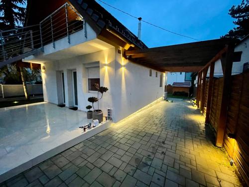 a patio of a house with lights on it at Felix House Siófok in Siófok