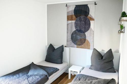 a bedroom with two beds and a painting on the wall at Work & Stay Apartment Ingolstadt in Ingolstadt