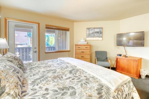 a bedroom with a bed and a dresser and a television at Icicle Village Resort 507 & 508: Alpine Reflections in Leavenworth