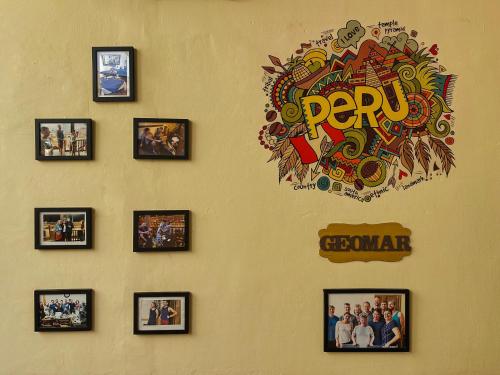 a wall with pictures of people on it at Villa La Punta in Lima