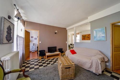 a bedroom with a bed and a living room at Gîte de Villecomte in Sainte-Solange