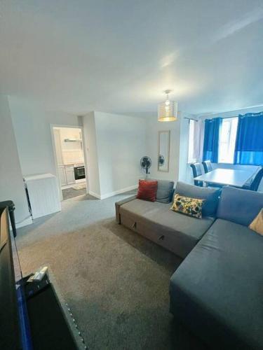 een woonkamer met een bank en een bed bij Cozy 2 Bed Flat in Cricklewood in Londen