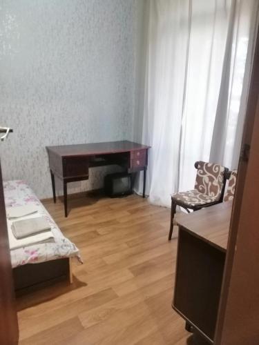 a room with a piano and a chair and a desk at Apartamenty u Deribasovskoi in Odesa