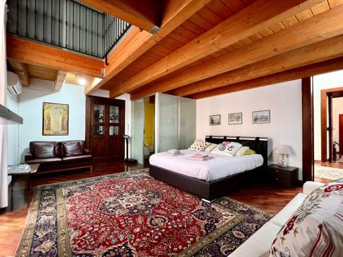 a bedroom with a large bed and a rug at Casa Vacanza Saint Patrick DImora del 1200 in Barletta