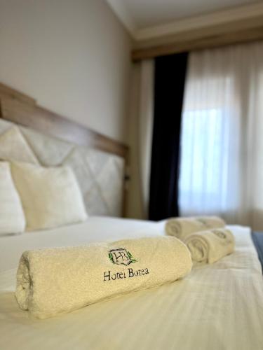 a hotel room with two towels on a bed at Hotel Borea in Peje