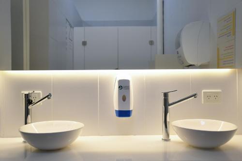 a bathroom with two white bowls on a counter at Casa Franca Recoleta Hostel Boutique in Buenos Aires