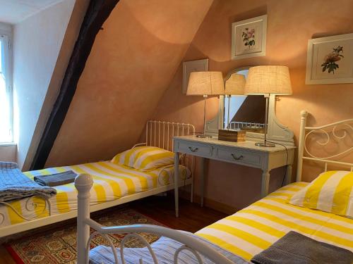 a bedroom with two beds and a desk with a mirror at Le Clos Romantic & Spa - Périgueux - Bassillac et Auberoche in Eyliac