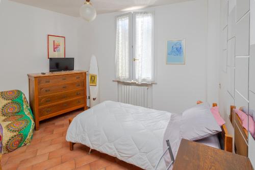a bedroom with a bed and a dresser and a television at Le Ruote in Vezzano sul Crostolo