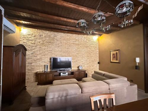 a living room with a couch and a flat screen tv at Casa vacanze bacio del sole in Palermo