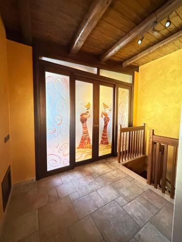 a room with sliding glass doors in a house at Bacio del sole Apartment in Palermo