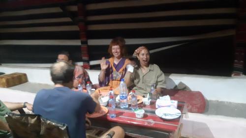 a group of people sitting around a table at happiness camp in Wadi Rum