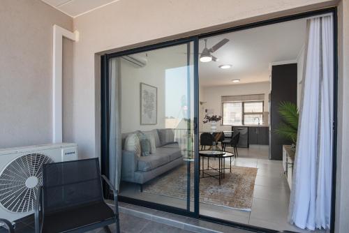 a living room with a couch and a table at Ballito Village Luxury Apartments in Ballito