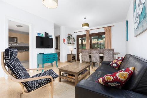 a living room with a couch and a table at Sunset Beach 4 Bedroom Villa 200m to Beach+Fast WIFI in Corralejo