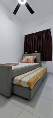 a bedroom with two beds and a ceiling fan at RF Homestay Nilai in Nilai