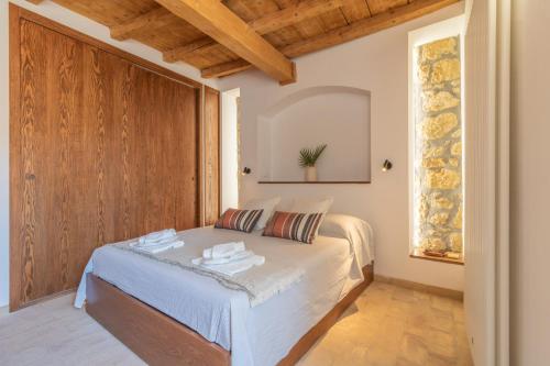 Schlafzimmer mit einem Bett und einer Holztür in der Unterkunft CasaViva - La Dimora del Buttero in Farnese