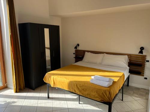 a bedroom with a bed with two towels on it at Napoli studio 106 in Naples