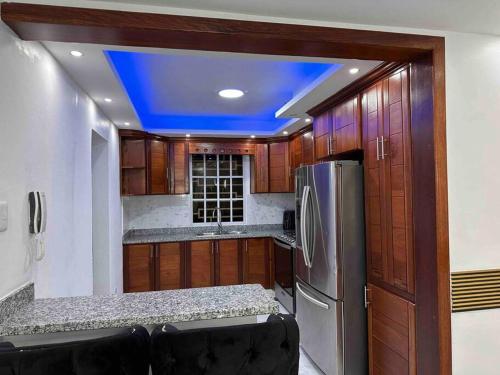 a kitchen with wooden cabinets and a blue ceiling at Hermoso lugar para compartir es muy acogedor in Mendoza