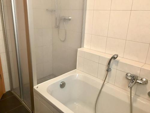 a bathroom with a shower and a bath tub at Ferienwohnung Strandgut in Langenargen