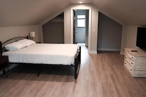 1 dormitorio con 1 cama, vestidor y TV en ✵ Newly Remodeled Lovely 4BDR Retreat ➠ 3191, en Traverse City