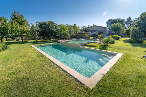a swimming pool in the middle of a yard at Gîte M in Codognan