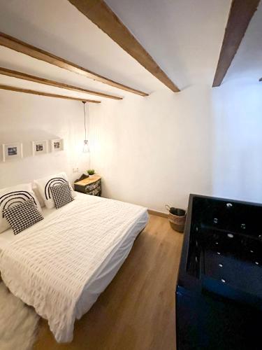 a bedroom with a white bed and a stove at Casa Cueva Luna in Orce