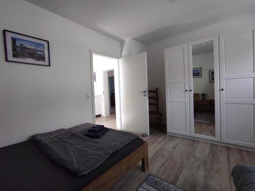 a bedroom with a bed and a large mirror at Ferienwohnung am Rathaus in Landstuhl