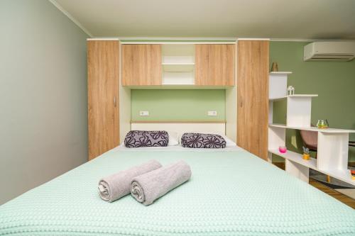 a bedroom with a bed with two towels on it at Studio Leon & rent a quad in Mali Lošinj