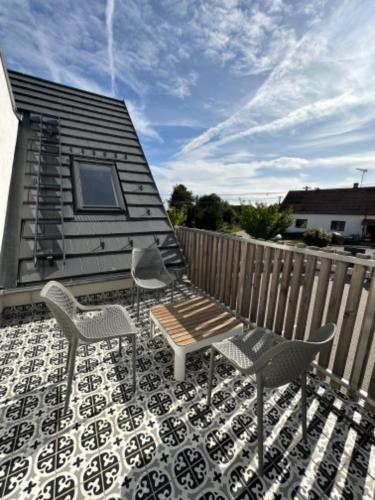 a patio with a table and chairs and a fence at Sousedi Pavlov in Pavlov