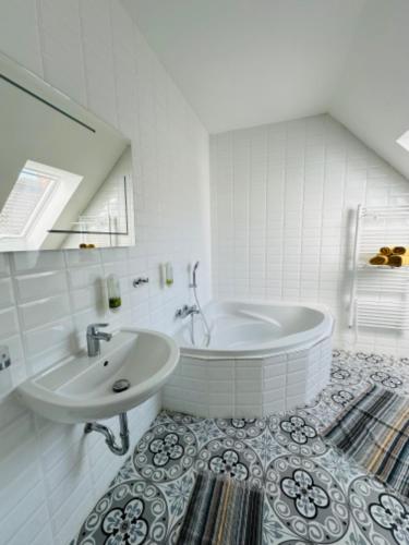 a white bathroom with a tub and a sink at Sousedi Pavlov in Pavlov