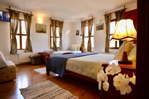 a bedroom with a bed with a lamp and flowers at Iliikova House in Kalofer