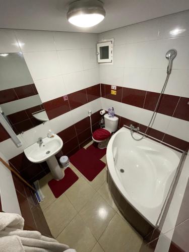 a bathroom with a sink and a tub and a toilet at private room chambre privée in Kenitra