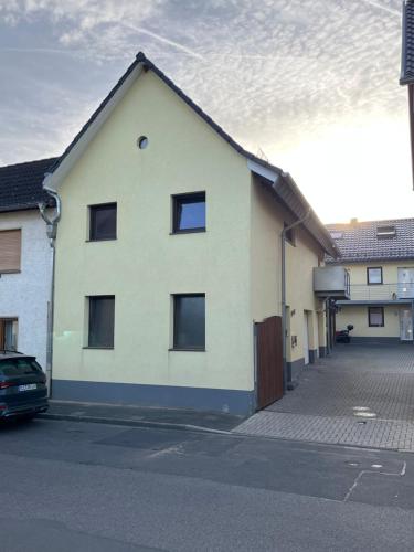 a white house with a car parked in front of it at Mini-Loft in schöner Voreifel in Mechernich
