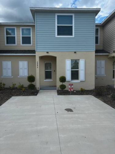 a large house with a driveway in front of it at Luxurious Farm Style House in Kissimmee