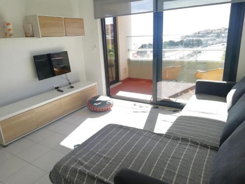 a living room with a couch and a flat screen tv at Buarcos&Sea Accommodation - Tonay Sol in Figueira da Foz