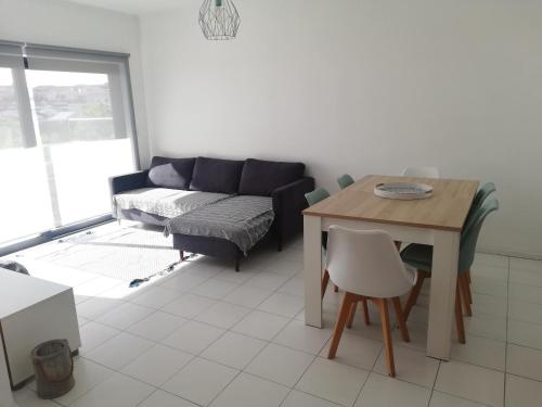 a living room with a couch and a table at Buarcos&Sea Accommodation - Tonay Sol in Figueira da Foz