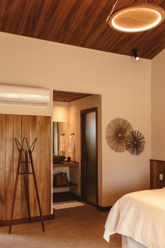 a bedroom with a bed and a wooden ceiling at Pousada Moana in Fernando de Noronha