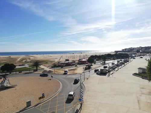 a street with cars parked on the beach at Buarcos&Sea Accommodation - Tonay Sol in Figueira da Foz