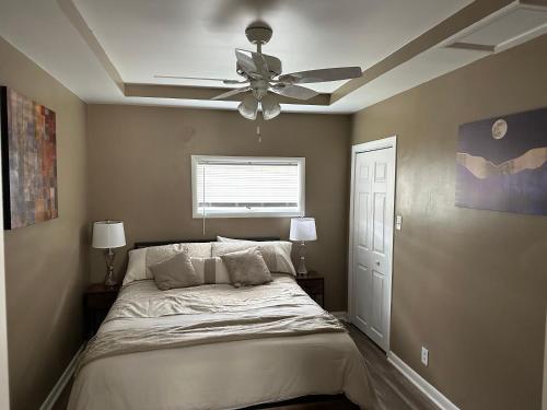 a bedroom with a bed with a ceiling fan at Modern Home Away From Home in Westover