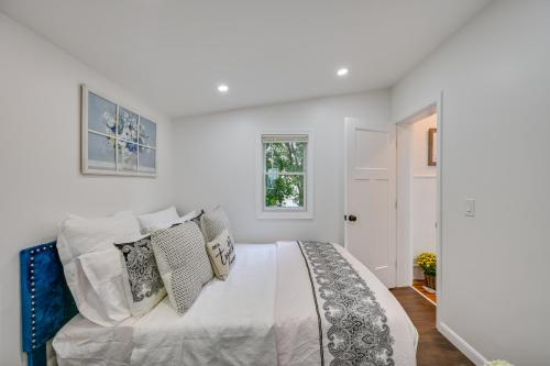 a white bedroom with a large bed with pillows at Charming Danvers Studio 5 Mi to Salem! in Danvers