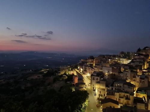 a view of a city at night at Mineo Townhouse with incredible views of Mt Etna in Mineo
