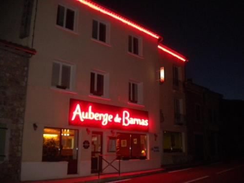 a building with a red neon sign on it at Auberge de Barnas in Barnas