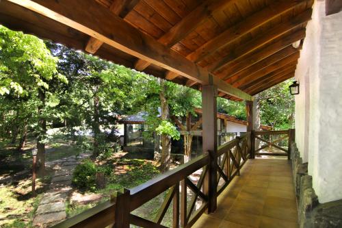 a porch of a house with a wooden roof at Posada del Sauce in Villa General Belgrano