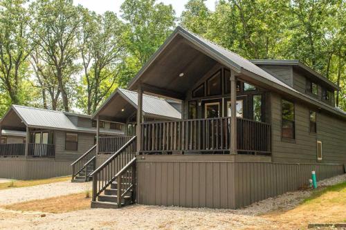 a modular home with a large porch and balcony at Jellystone Park Tyler in Tyler
